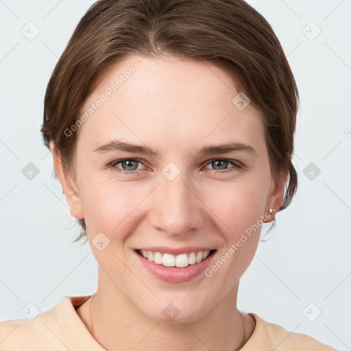 Joyful white young-adult female with short  brown hair and grey eyes