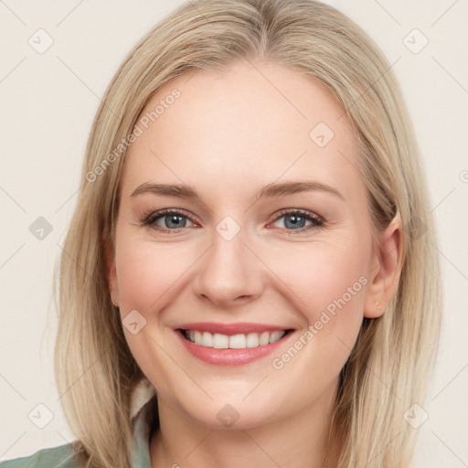 Joyful white young-adult female with long  brown hair and blue eyes