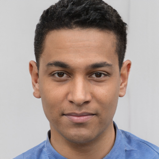 Joyful white young-adult male with short  black hair and brown eyes