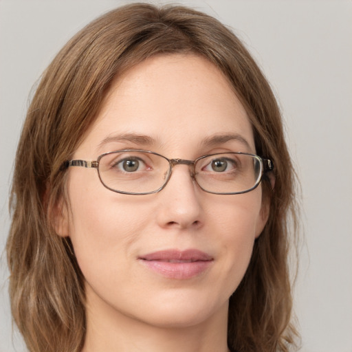 Joyful white young-adult female with long  brown hair and green eyes