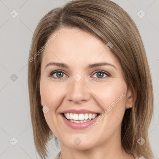 Joyful white young-adult female with medium  brown hair and grey eyes