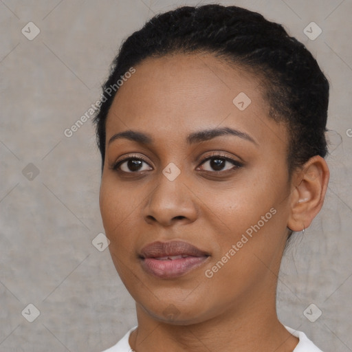 Joyful black young-adult female with short  black hair and brown eyes