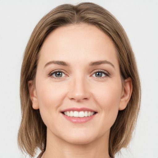 Joyful white young-adult female with long  brown hair and grey eyes