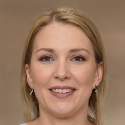 Joyful white adult female with medium  brown hair and grey eyes