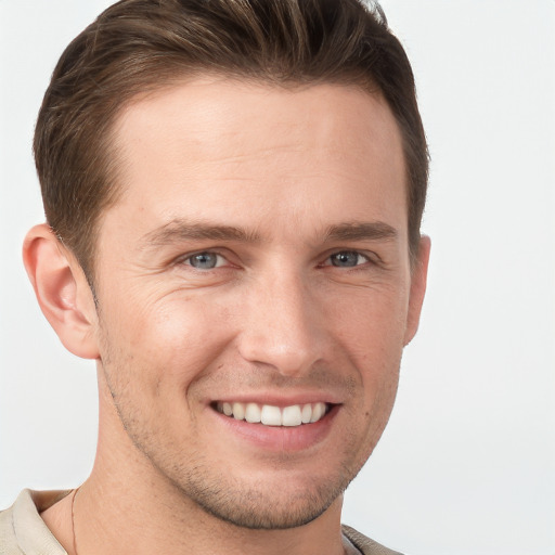 Joyful white young-adult male with short  brown hair and grey eyes