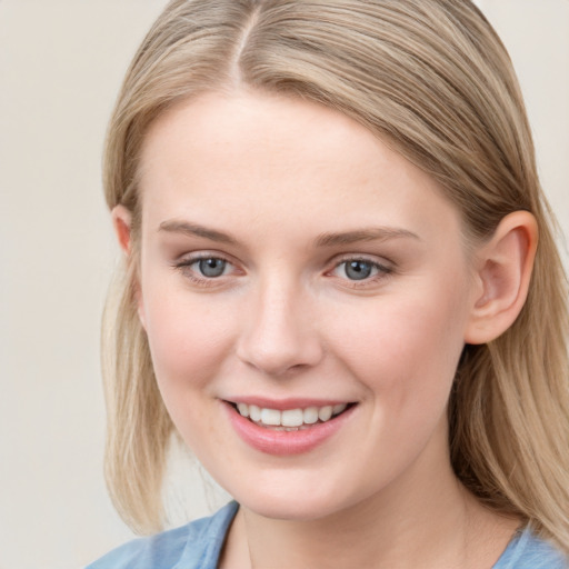 Joyful white young-adult female with long  brown hair and blue eyes