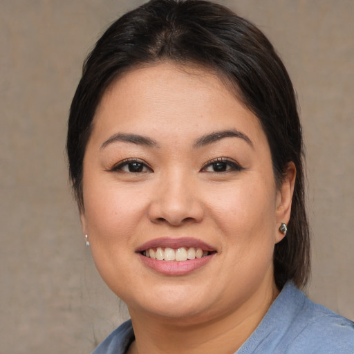 Joyful asian young-adult female with medium  brown hair and brown eyes