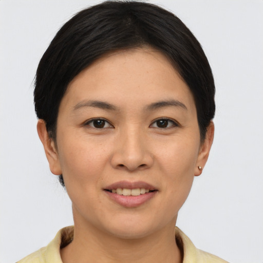 Joyful asian young-adult female with short  brown hair and brown eyes