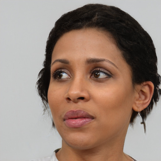 Joyful black young-adult female with medium  black hair and brown eyes