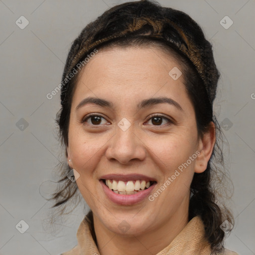 Joyful latino young-adult female with medium  brown hair and brown eyes