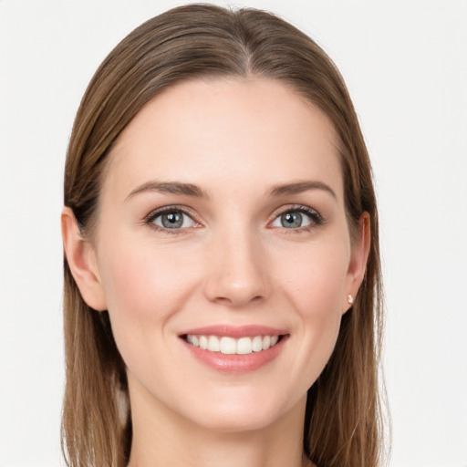 Joyful white young-adult female with long  brown hair and grey eyes