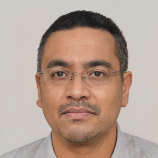 Neutral latino adult male with short  black hair and brown eyes
