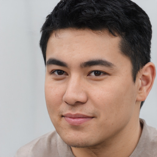 Joyful latino young-adult male with short  brown hair and brown eyes
