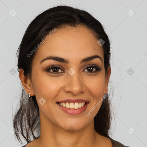 Joyful latino young-adult female with long  brown hair and brown eyes