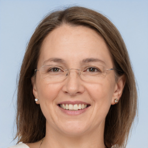 Joyful white adult female with medium  brown hair and grey eyes