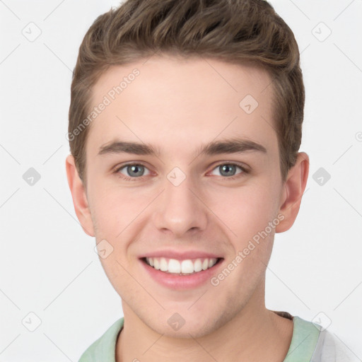 Joyful white young-adult male with short  brown hair and grey eyes