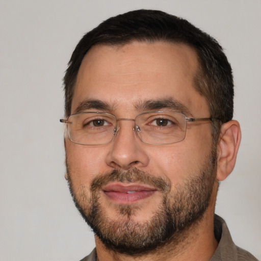 Joyful white adult male with short  brown hair and brown eyes