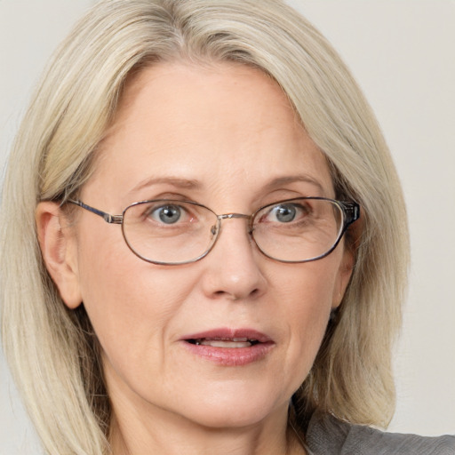 Joyful white middle-aged female with medium  brown hair and blue eyes