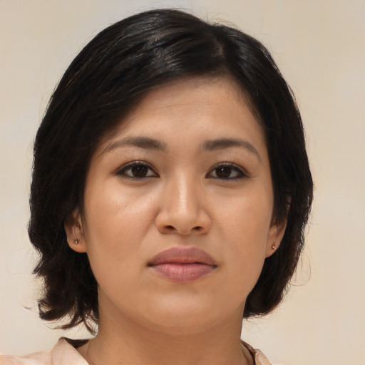Joyful asian young-adult female with medium  brown hair and brown eyes