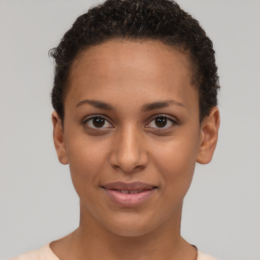 Joyful latino young-adult female with short  brown hair and brown eyes
