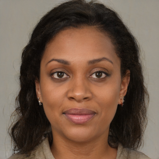 Joyful black young-adult female with medium  brown hair and brown eyes