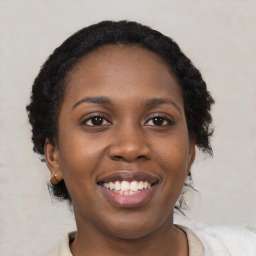 Joyful black young-adult female with medium  brown hair and brown eyes