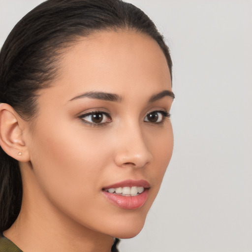 Joyful latino young-adult female with long  brown hair and brown eyes