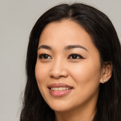 Joyful asian young-adult female with long  black hair and brown eyes