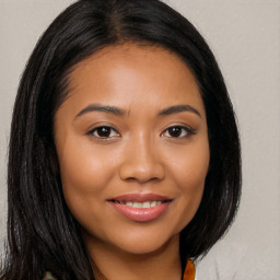 Joyful latino young-adult female with long  brown hair and brown eyes