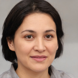 Joyful white adult female with medium  brown hair and brown eyes