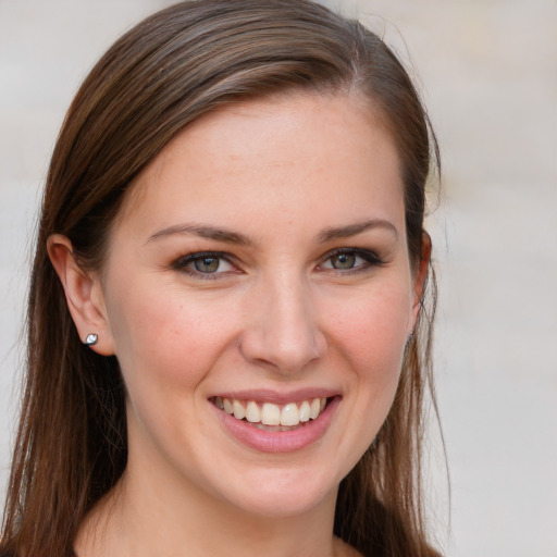 Joyful white young-adult female with long  brown hair and blue eyes