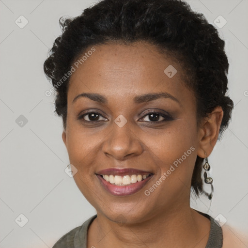 Joyful black young-adult female with short  brown hair and brown eyes