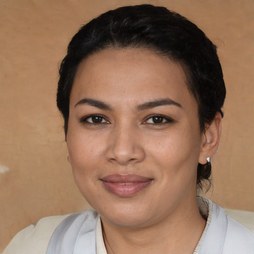 Joyful latino young-adult female with short  black hair and brown eyes