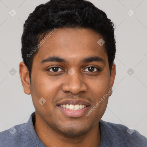 Joyful black young-adult male with short  black hair and brown eyes