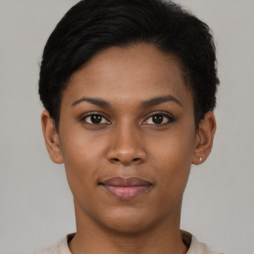 Joyful black young-adult female with short  brown hair and brown eyes