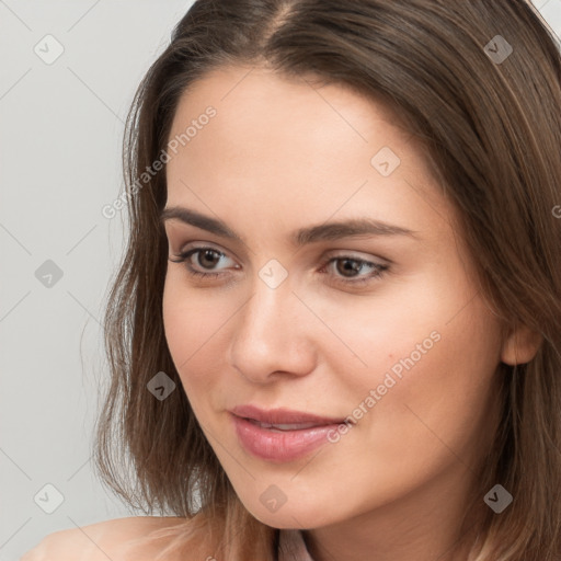 Neutral white young-adult female with long  brown hair and brown eyes