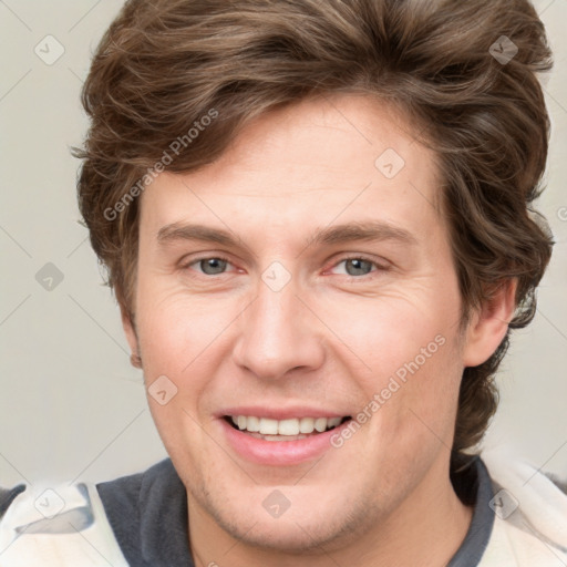 Joyful white adult male with short  brown hair and grey eyes