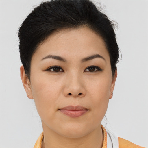 Joyful asian young-adult female with short  brown hair and brown eyes