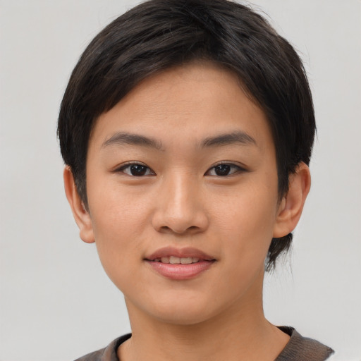 Joyful asian young-adult female with short  brown hair and brown eyes