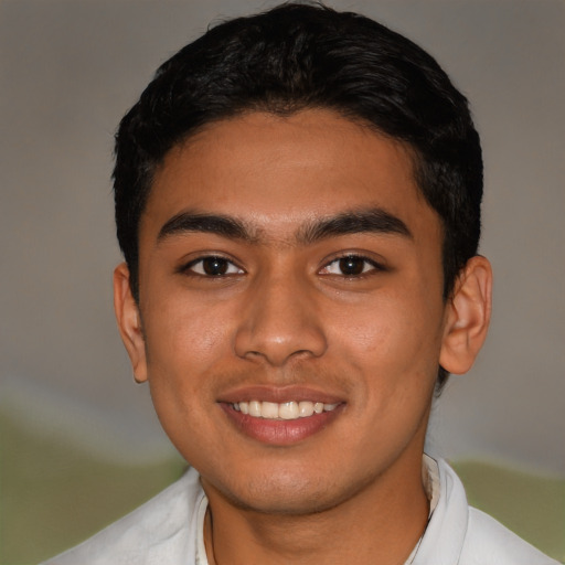 Joyful latino young-adult male with short  black hair and brown eyes