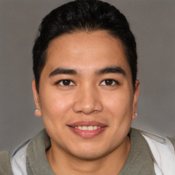 Joyful asian young-adult male with short  brown hair and brown eyes