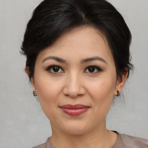 Joyful asian young-adult female with medium  brown hair and brown eyes
