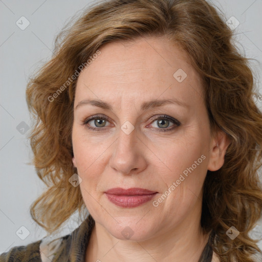 Joyful white adult female with medium  brown hair and green eyes