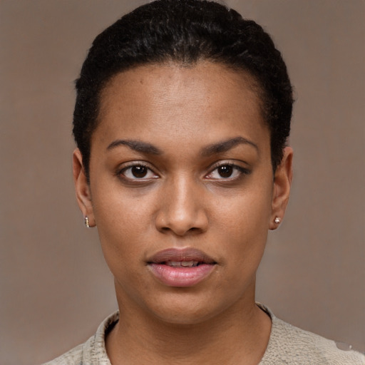 Joyful black young-adult female with short  black hair and brown eyes