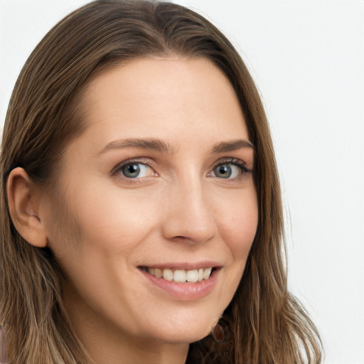 Joyful white young-adult female with long  brown hair and grey eyes