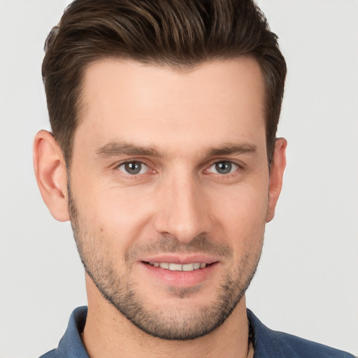 Joyful white young-adult male with short  brown hair and brown eyes