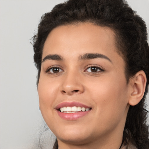 Joyful white young-adult female with long  black hair and brown eyes