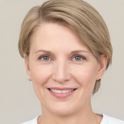 Joyful white adult female with medium  brown hair and grey eyes