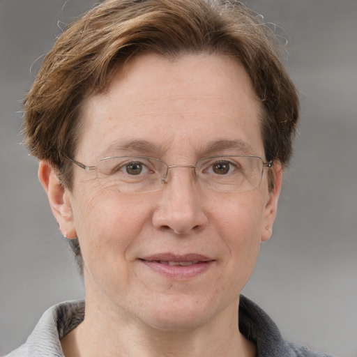 Joyful white middle-aged female with short  brown hair and grey eyes