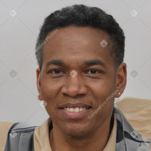 Joyful black adult male with short  black hair and brown eyes
